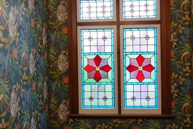Stairway with stained glass and wallpaper in The Vicarage Geraldine luxury hotel accommodation