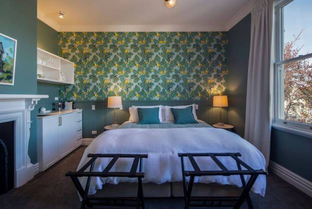 Superking bedroom with historic fireplace at The Vicarage Geraldine luxury hotel accommodation